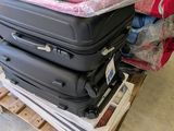 several pieces of luggage stacked on top of each other on a pallet