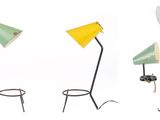 three different colored lamps sitting on top of a table next to each other