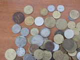 a pile of coins sitting on a wooden table