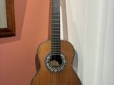 a guitar that is sitting on top of a stack of books