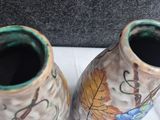 two vases that are sitting on a table