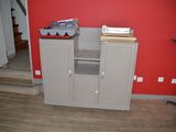 an image of a kitchen with red walls and wood flooring