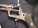 a gun that is sitting on a black cloth