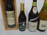 three bottles of wine are in a wooden box on a table