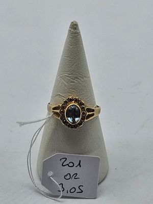 an image of a gold ring with a blue stone on it