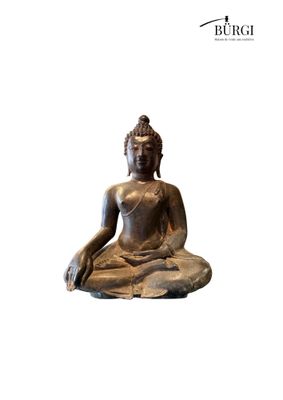 statue of a seated buddha sitting on a rock on a white background