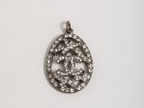 a silver pendant with a circular design and small diamonds on it