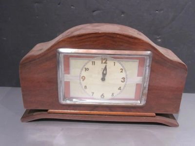 a wooden clock that is sitting on a table