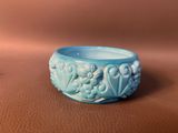 a blue bowl sitting on top of a brown table