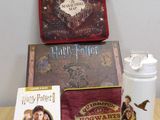 a harry potter book, a water bottle, and a book on a table