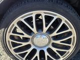 a close up of a car ' s tire on a gravel road