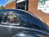 a black car that is parked outside of a building