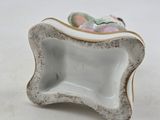 a small white bowl with a flower on it