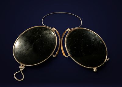 une paire de boucles d'oreilles ovales en verre noir, dotées d'un fermoir doré