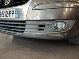 a silver car parked in a garage with a license plate on the front