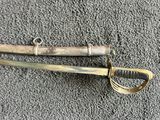 an old and worn sword laying on the ground next to a pair of scissors