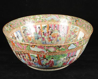 a large bowl with a painting on it on a black background