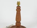 an image of a wooden table lamp with a cord plugged into it