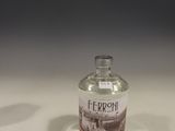 a small bottle of liquor sitting on a table