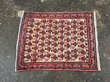 an old persian rug on the ground