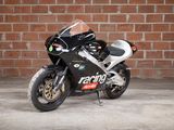 a motorcycle parked in front of a brick wall