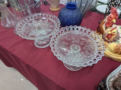 several glass dishes and vases on a table with a red table cloth