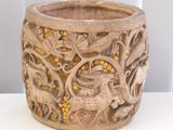 a wooden bowl with carvings on it sitting on a table