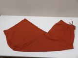 an orange pants sitting on top of a white table