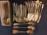 many spoons and forks in a box on the table
