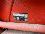 a close up of a red tractor with a sign on it