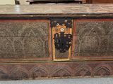 a very old wooden chest sitting on the floor