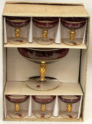 six wine glasses in a cardboard box with gold accents