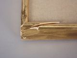 an old picture frame with a piece of wood sticking out of it