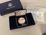 a silver coin sitting on a table next to other items