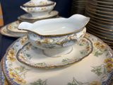 a lot of plates and bowls that are on a table