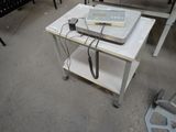 a small table with a computer on it in a room
