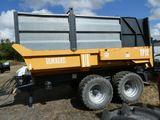 a dump truck that is parked in the dirt