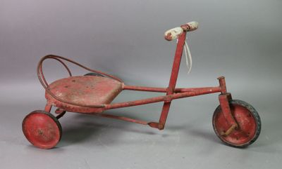 an old fashioned red tricycle with a wooden seat and wheels