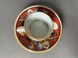 a cup and saucer sitting on a table