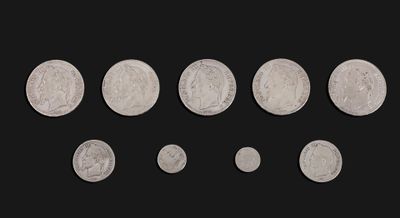 six different types of silver coins on a black background