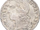 a silver coin with a woman ' s head on it