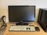 a computer monitor, keyboard, mouse and mouse on a desk