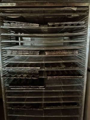many trays of food that are sitting on a rack