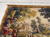 a tapestry hanging on the wall with birds and flowers on it