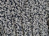 a close up of a shirt on a hanger on a wall