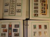 three pages of a book with stamps on them sitting on top of a table