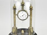 a glass dome with a clock inside of it
