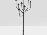 a black metal candelier with five candles on a stand