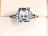an image of a ring with a blue topaz stone in it