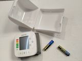 a small device that is sitting on a table next to batteries